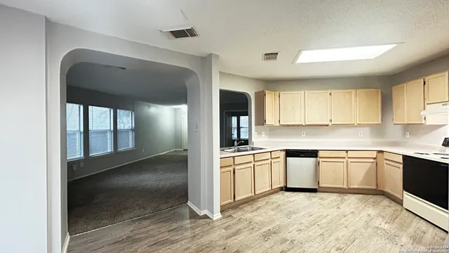 a large kitchen with cabinets and stainless steel appliances