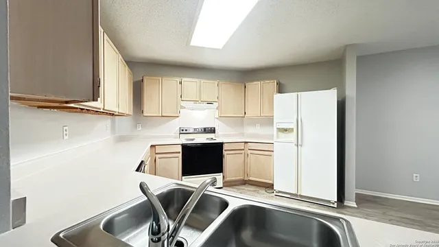 a view of kitchen with appliances and cabinets