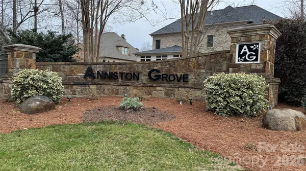 a view of a house with a yard and potted plants