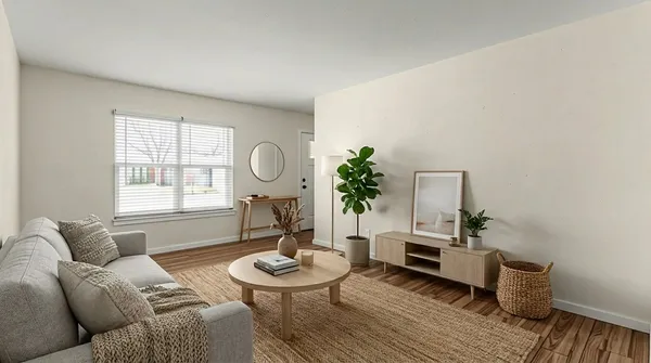 a living room with furniture and wooden floor