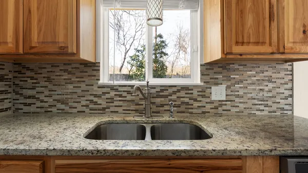 a kitchen with stainless steel appliances wooden cabinets and a sink