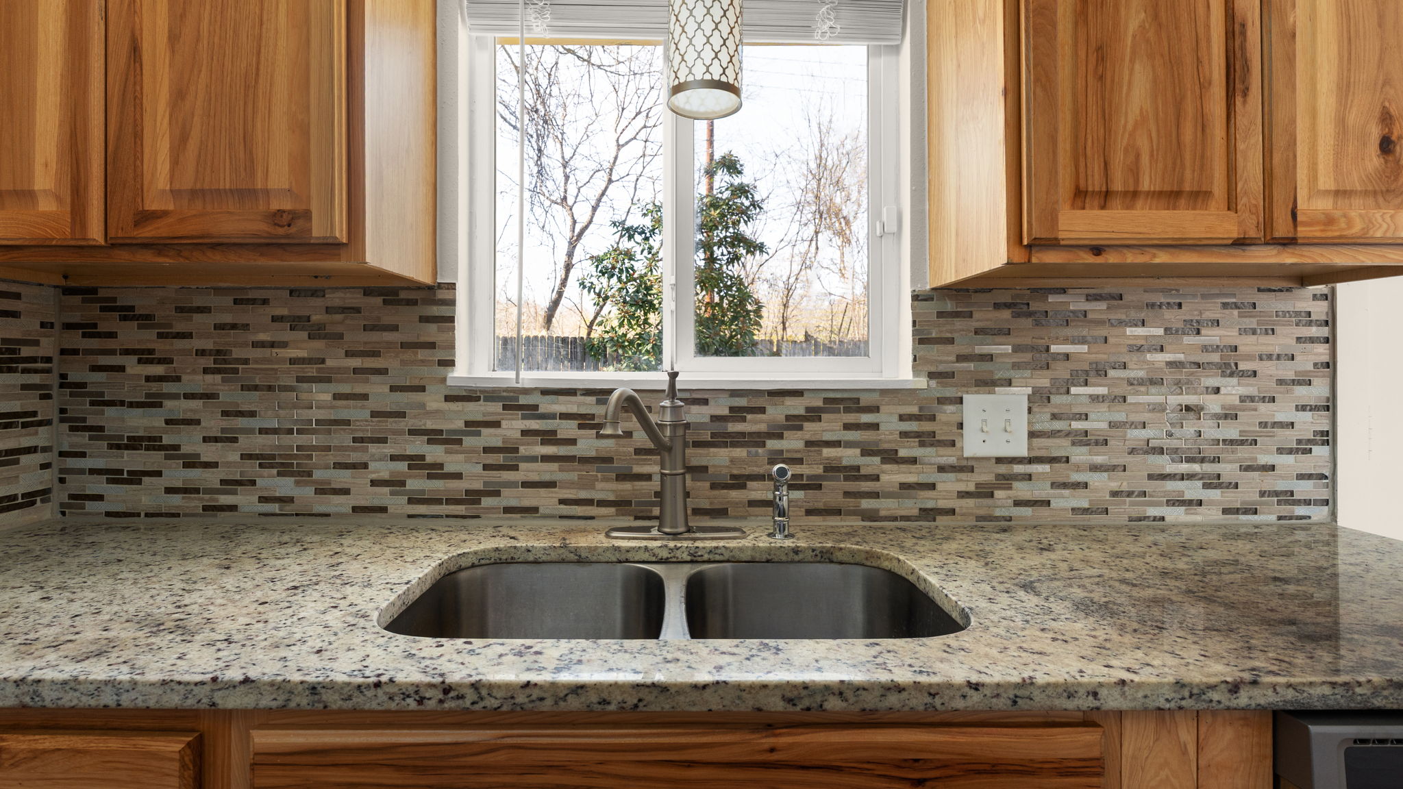 1618 Chippeway Lane Austin, TX 78745 - Photo 11 of 39 Kitchen featuring wood finish cabinets, light stone countertops, and healthy amount of natural light