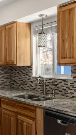 a kitchen with granite countertop cabinets stove and microwave