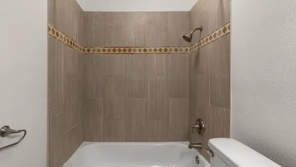 a view of an empty room with closet and a window