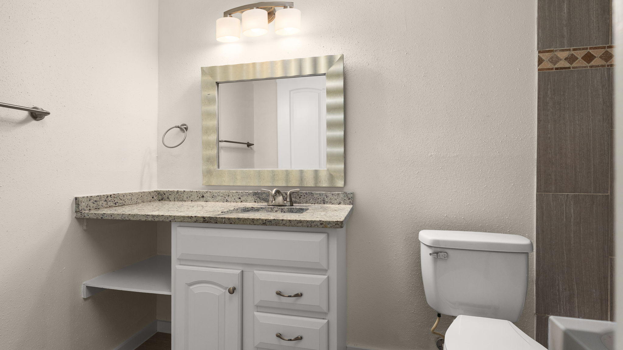1618 Chippeway Lane Austin, TX 78745 - Photo 28 of 39 Full bathroom with vanity and a textured wall