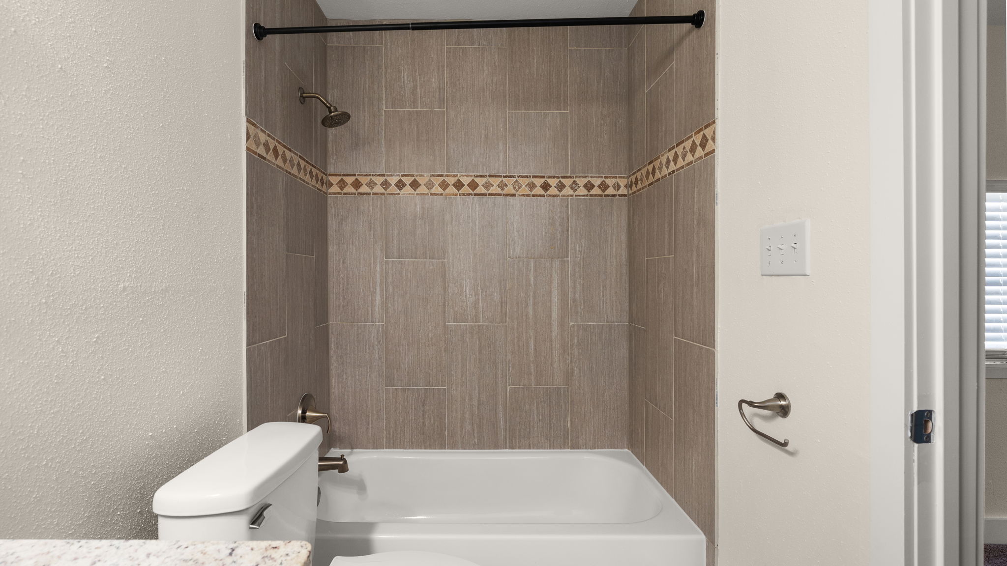 1618 Chippeway Lane Austin, TX 78745 - Photo 29 of 39 Bathroom with washtub / shower combination, a textured wall, and vanity