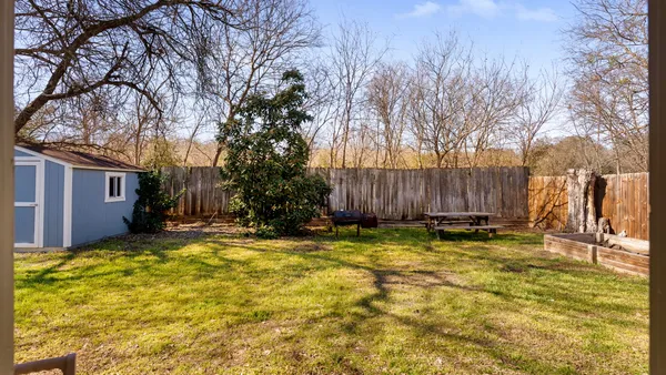 a view of a backyard with plants and a patio