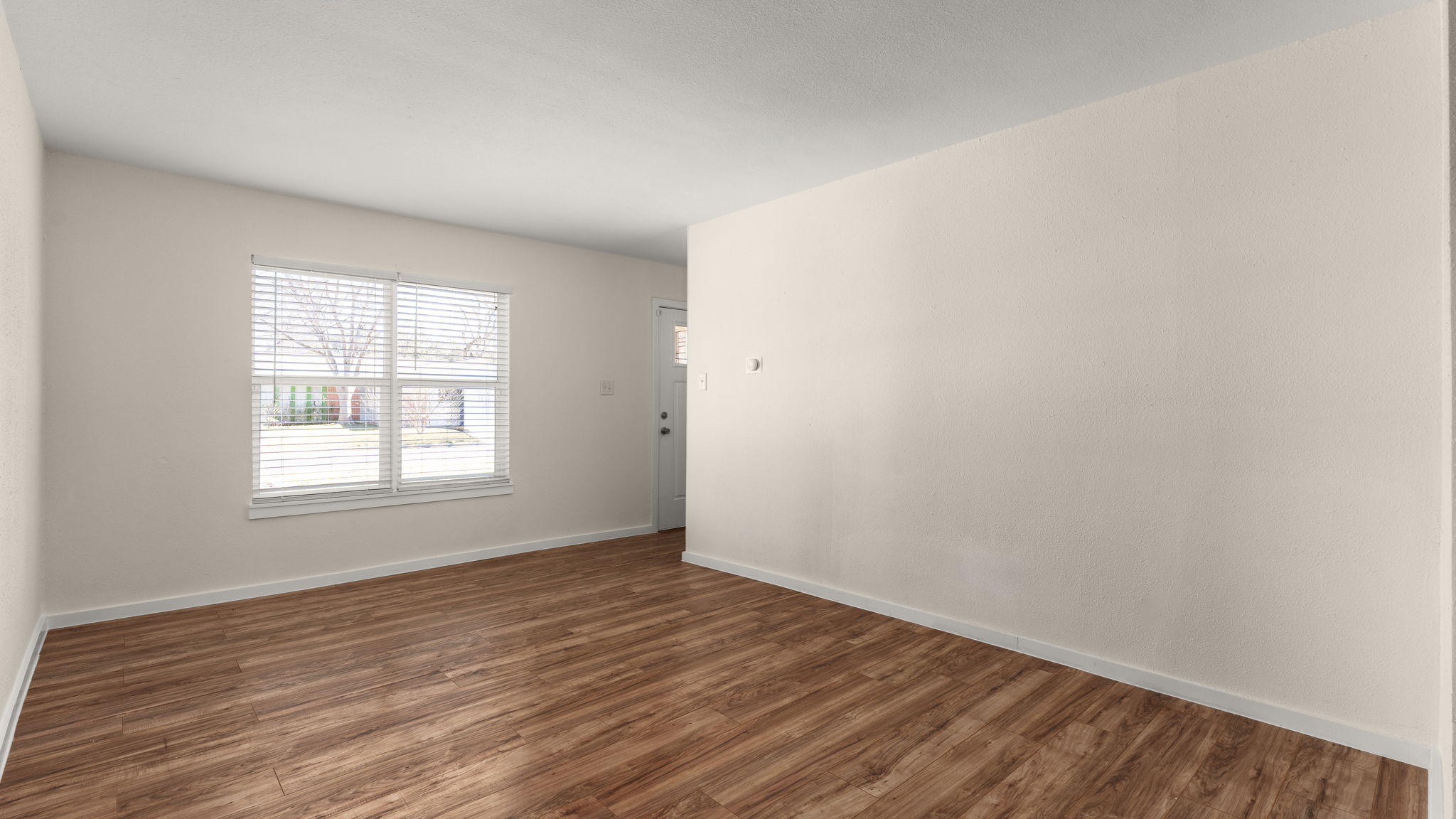 1618 Chippeway Lane Austin, TX 78745 - Photo 4 of 39 Living room, featuring fresh paint, double pane windows, luxury vinyl plank flooring