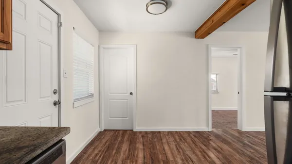 a view of a hallway view with wooden floor and staircase