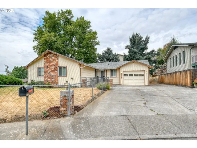 a view of house with backyard and swimming pool