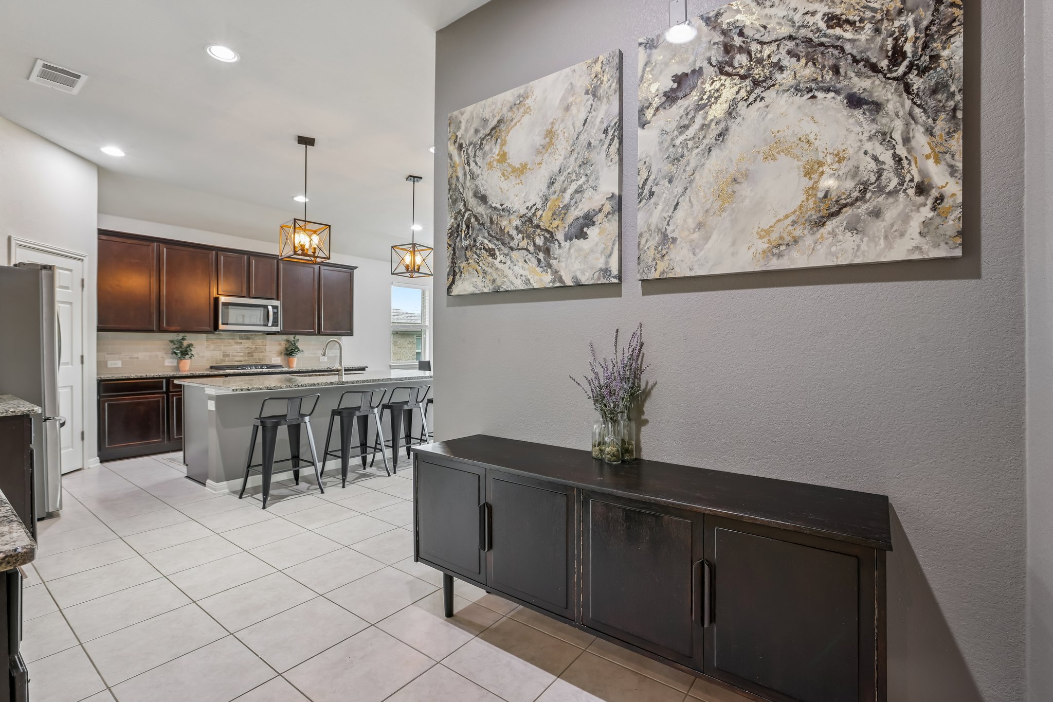 6801 Banff Cove Austin, TX 78754 - Photo 22 of 37 An inviting open-concept kitchen features a spacious island and contemporary lighting