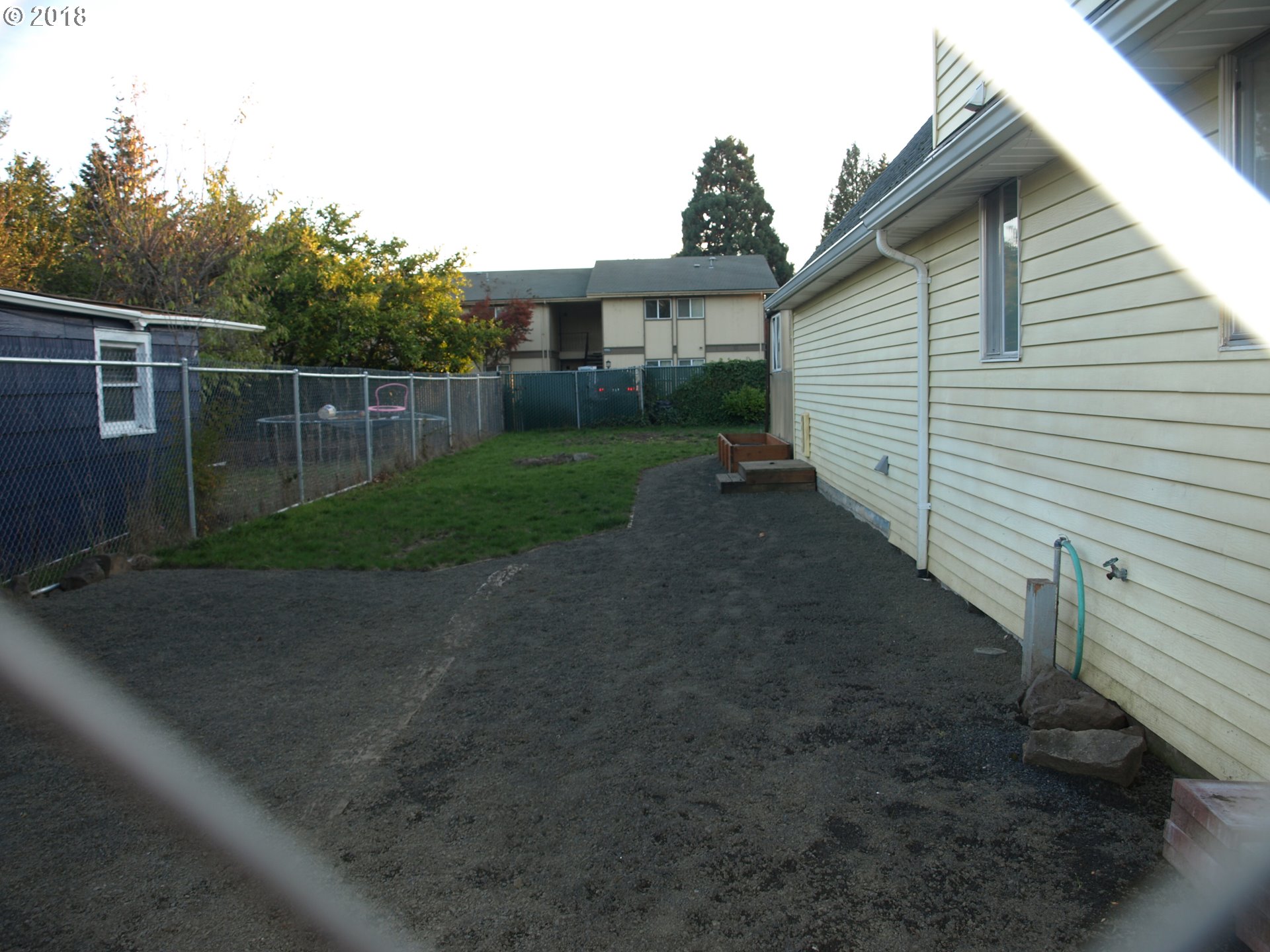 661 West M Street Springfield, OR 97477 - Photo 13 of 13 a view of a backyard with plants and white walls