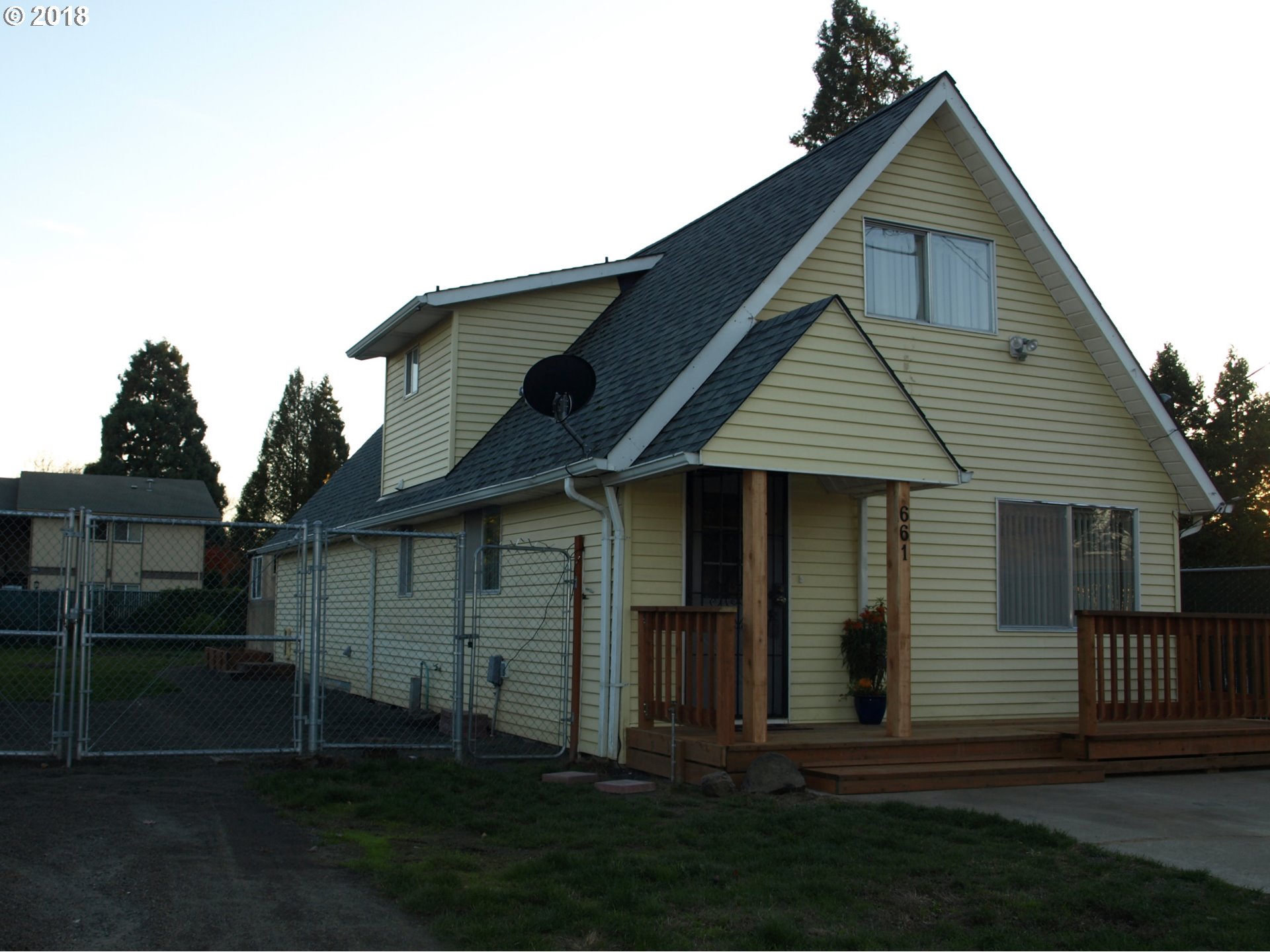 661 West M Street Springfield, OR 97477 - Photo 2 of 13 a front view of a house with a yard