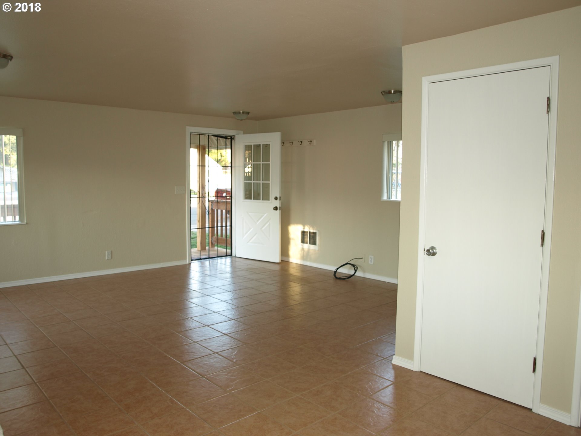 661 West M Street Springfield, OR 97477 - Photo 3 of 13 an empty room with wooden floor and windows