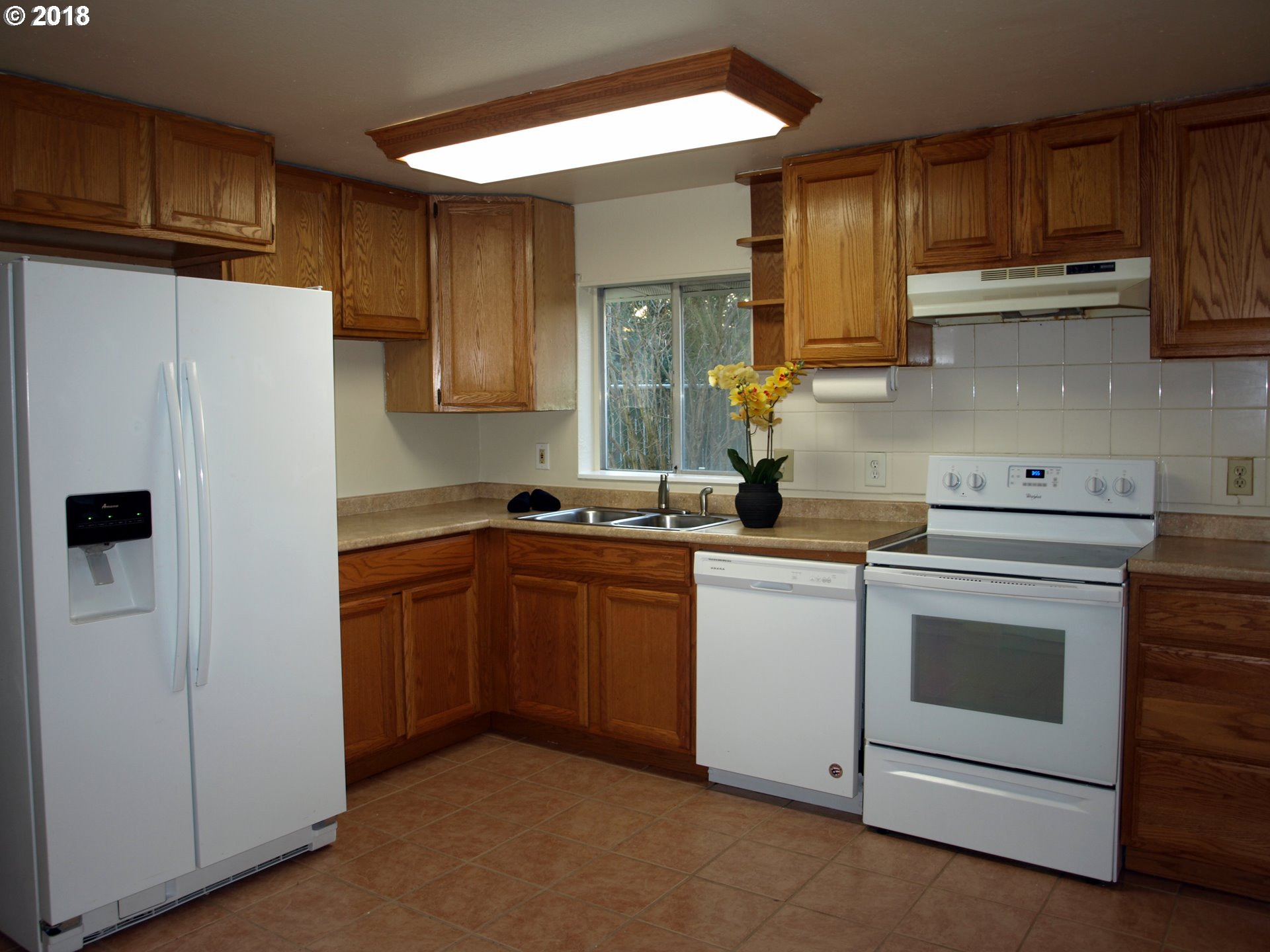 661 West M Street Springfield, OR 97477 - Photo 5 of 13 a kitchen with stainless steel appliances granite countertop a refrigerator sink and stove