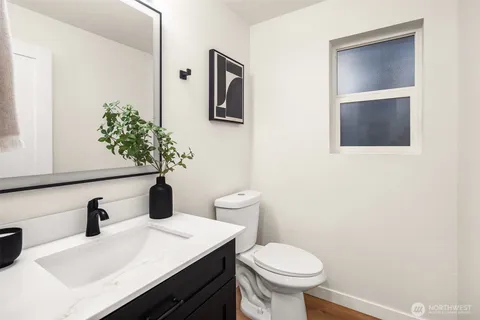 a bathroom with a sink toilet and vanity