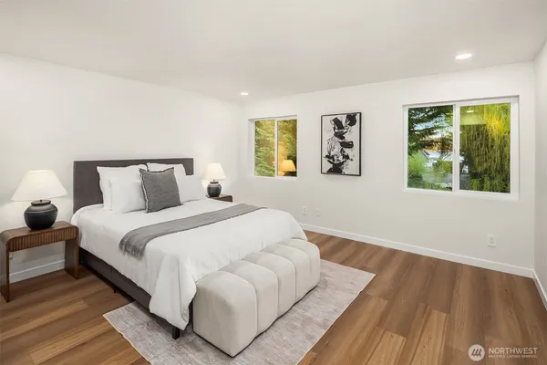 a bedroom with a bed and wooden floor