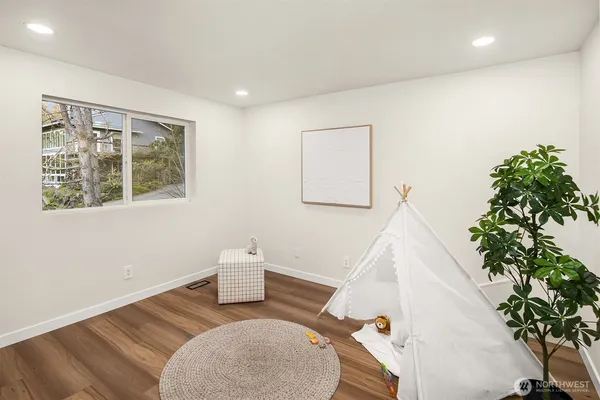 a view of room with window and wooden floor