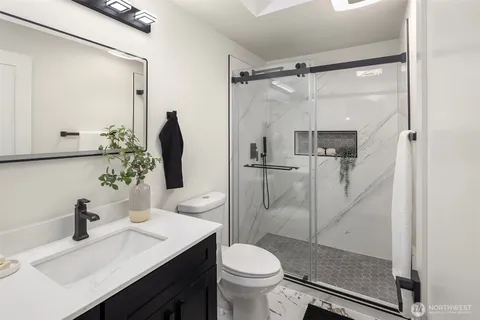a bathroom with a sink toilet and shower