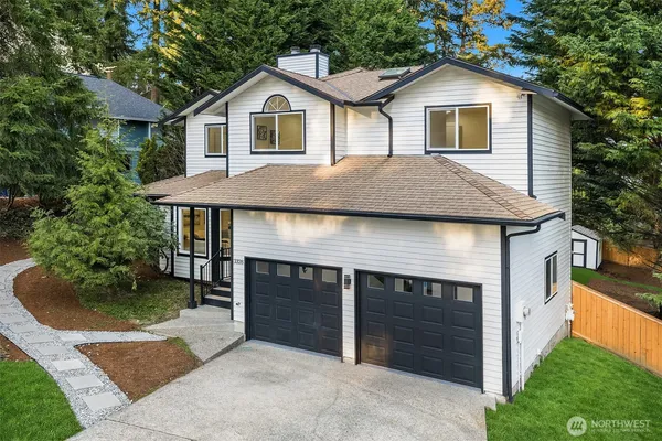 a front view of a house with a yard and garage