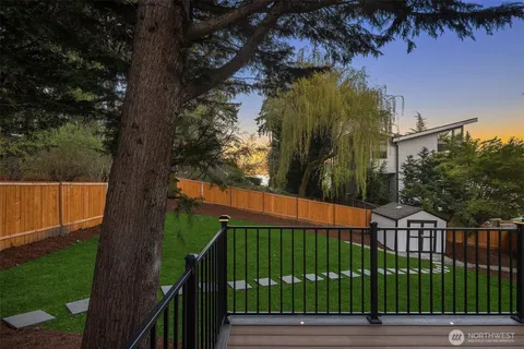 a view of backyard with deck and trees