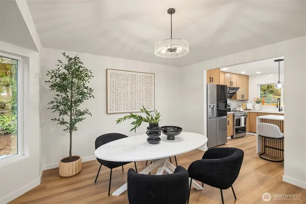 a view of a dining room with furniture and wooden floor