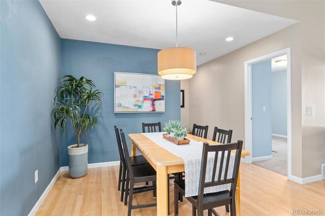 a view of a dining room with furniture a chandelier and wooden floor