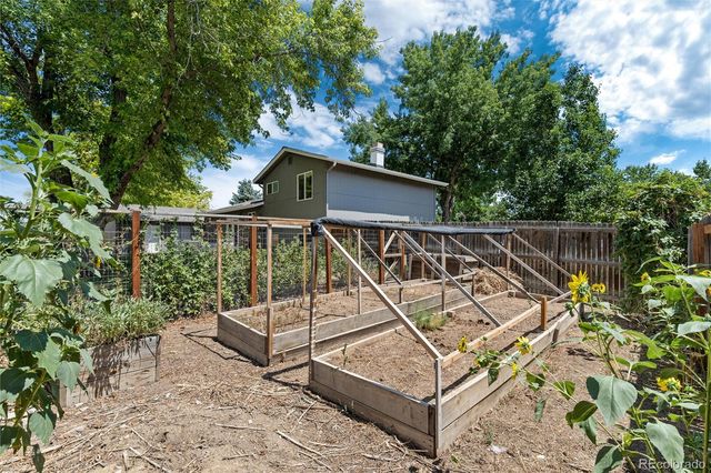 a view of a roof deck with wooden floor and fence