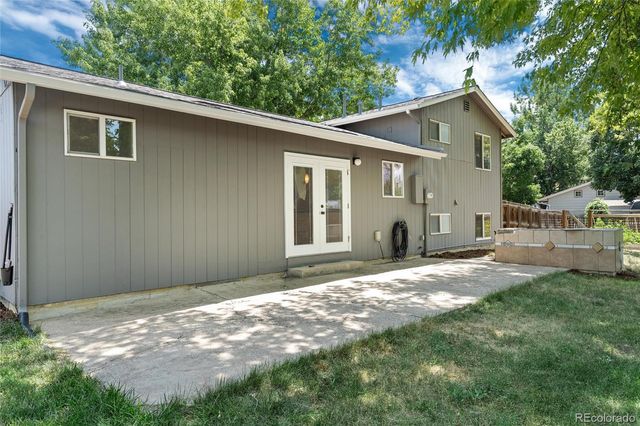 a backyard of a house with table and chairs