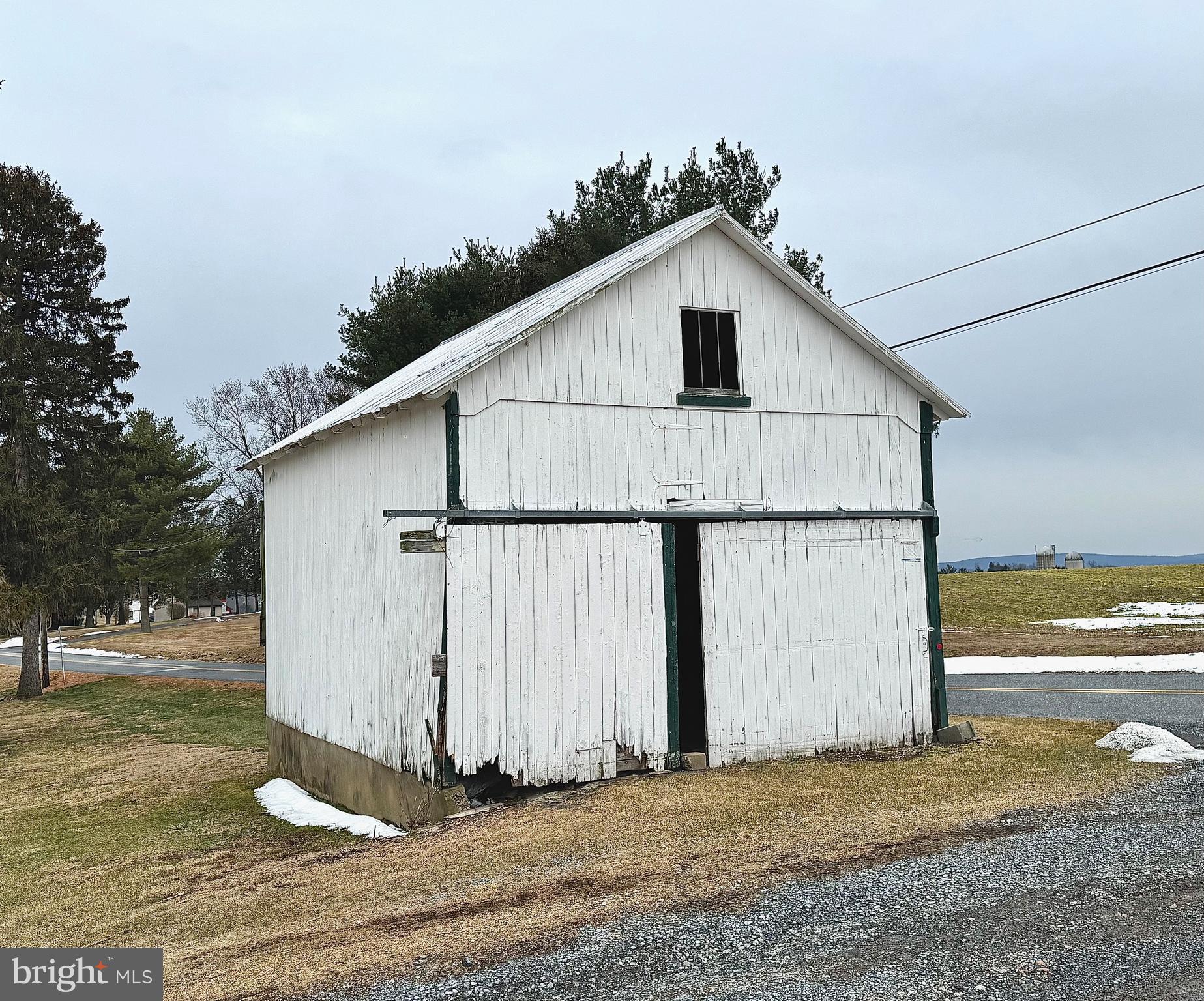 133 Hunter Road Oley, PA 19547 - Photo 25 of 29 a white house with a small yard and wooden fence