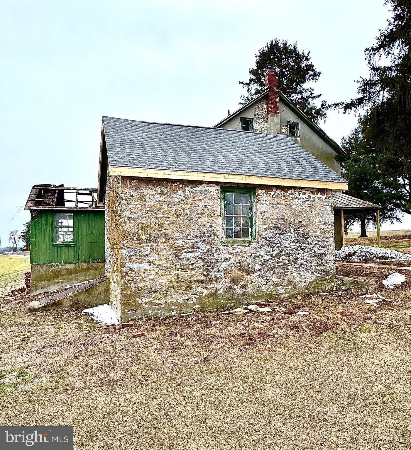 133 Hunter Road Oley, PA 19547 - Photo 28 of 29 a brick house with a small yard and large trees