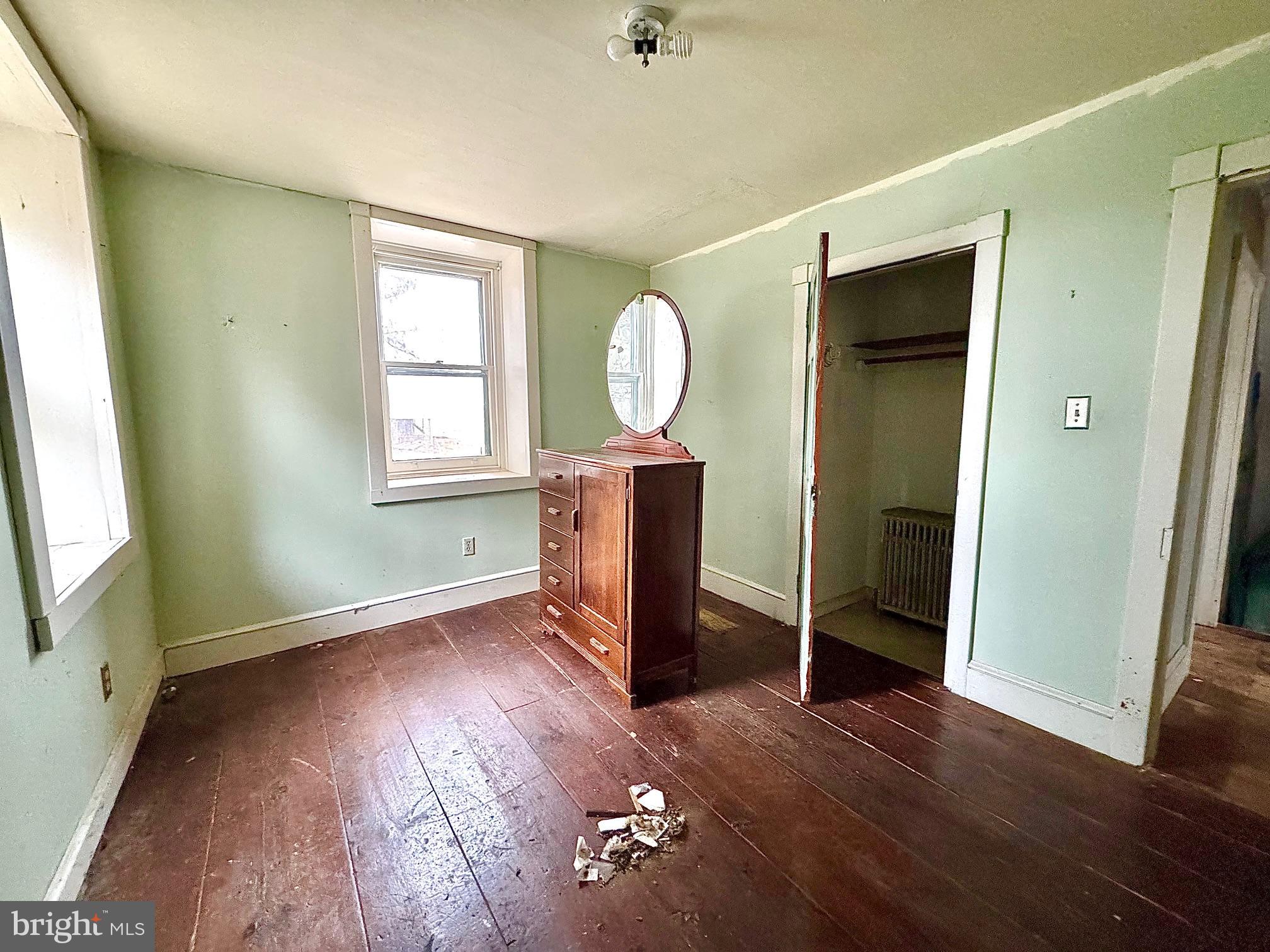 133 Hunter Road Oley, PA 19547 - Photo 8 of 29 an empty room with wooden floor mirror and windows