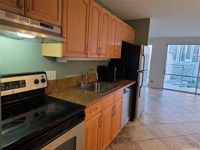 a kitchen with stainless steel appliances a stove a sink a microwave and refrigerator