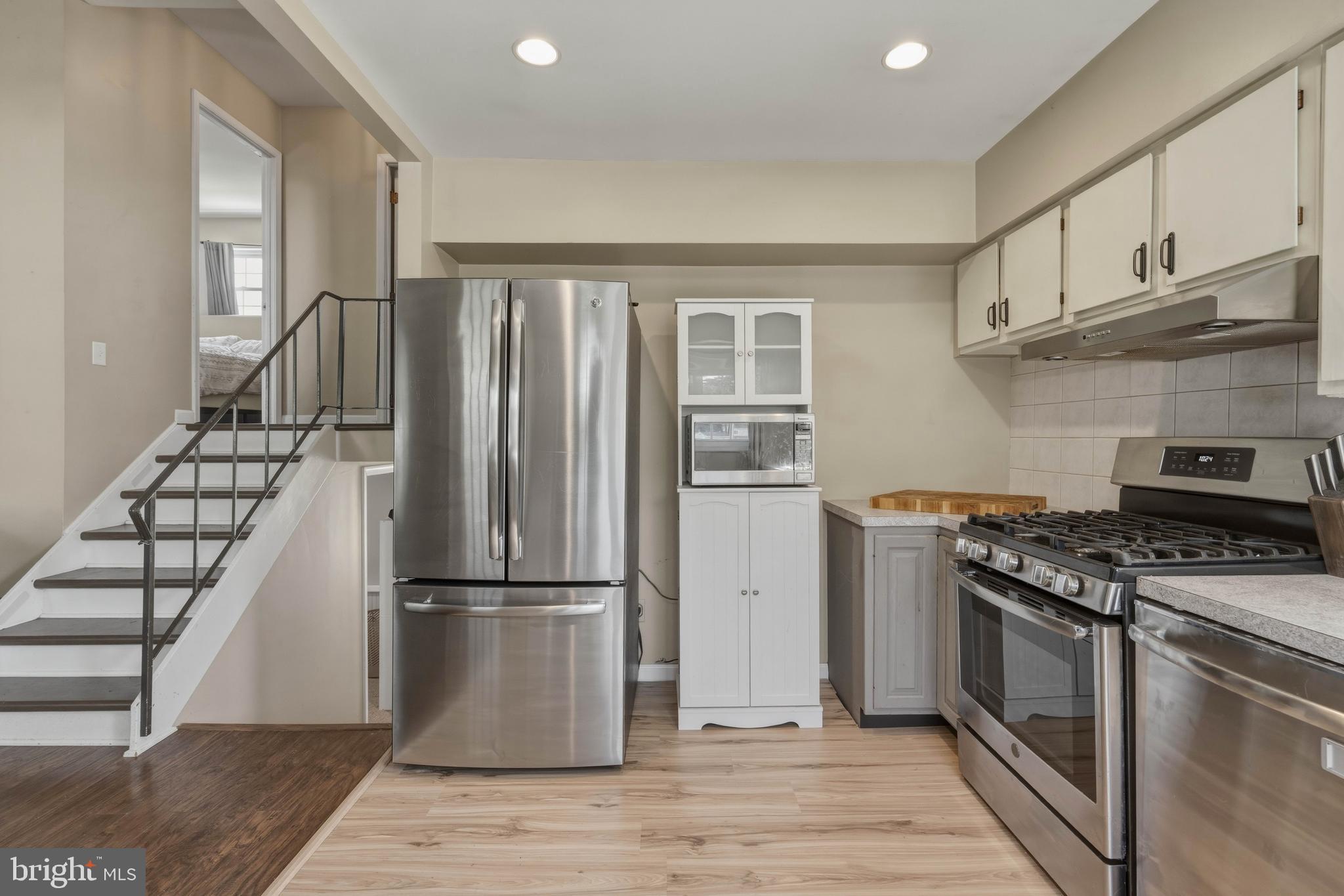 276 Madison Road Mantua, NJ 08051 - Photo 11 of 30 a kitchen with wooden floors and appliances