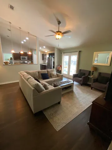a living room with furniture and a chandelier