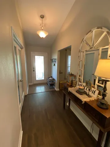 a view of a livingroom with furniture and a bathroom