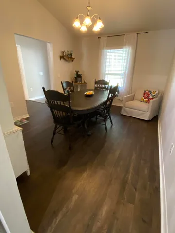 a view of a dining room with furniture and window