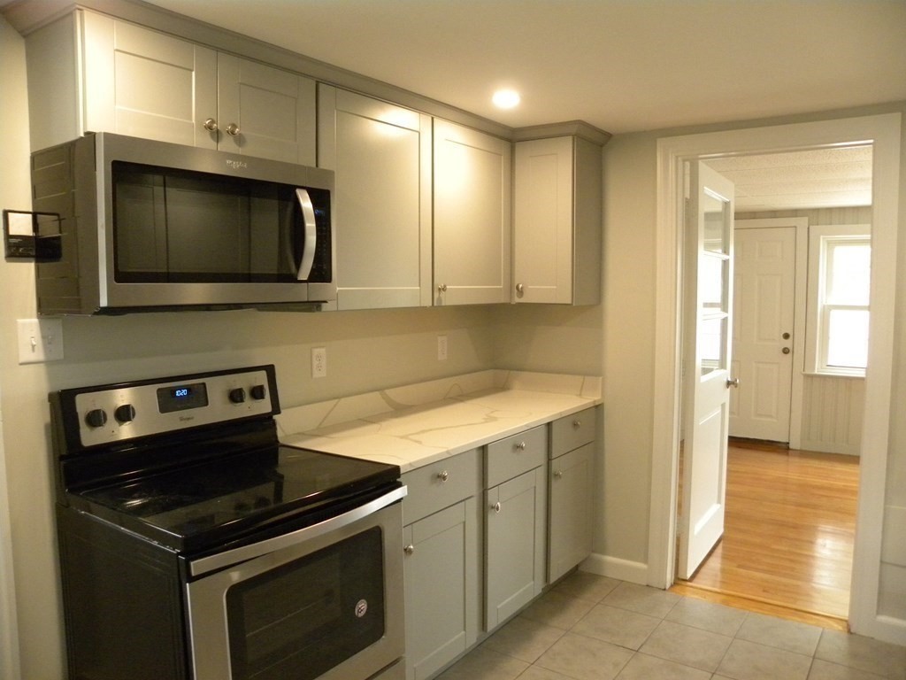 30 Arbor Road Chelmsford, MA 01863 - Photo 11 of 32 a kitchen with a stove and a microwave