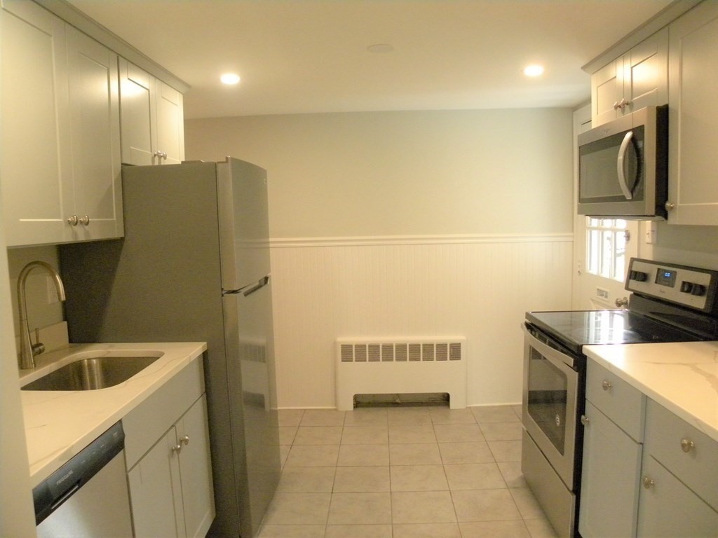 30 Arbor Road Chelmsford, MA 01863 - Photo 12 of 32 a kitchen with a refrigerator and a sink