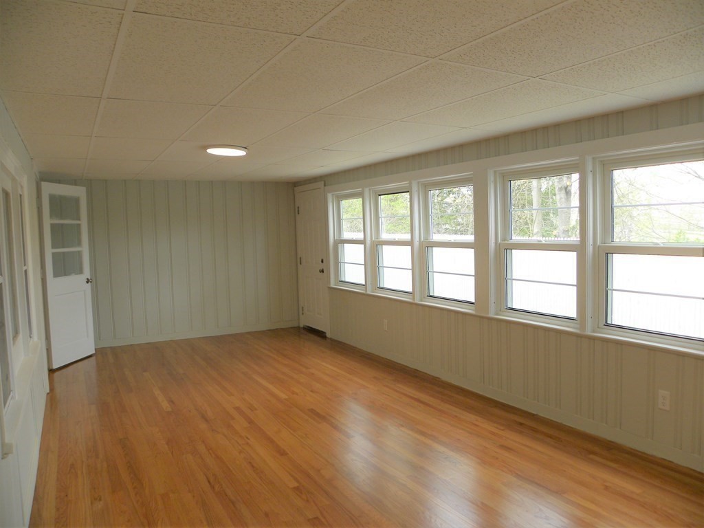 30 Arbor Road Chelmsford, MA 01863 - Photo 15 of 32 an empty room with wooden floor and windows