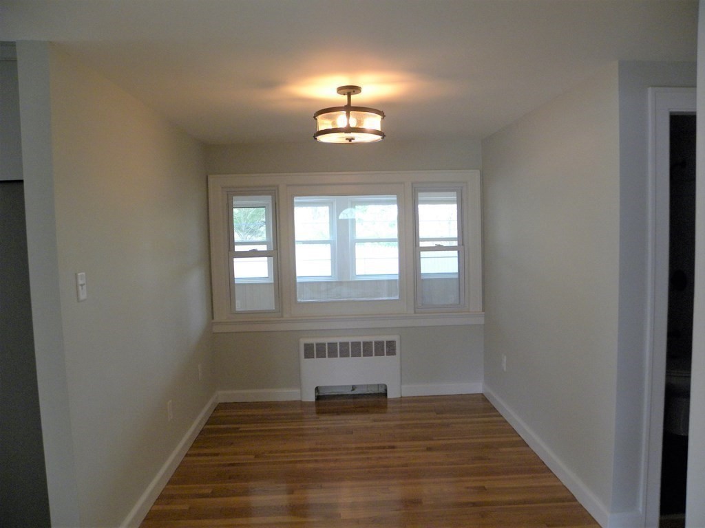 30 Arbor Road Chelmsford, MA 01863 - Photo 16 of 32 a view of an empty room with wooden floor and a window