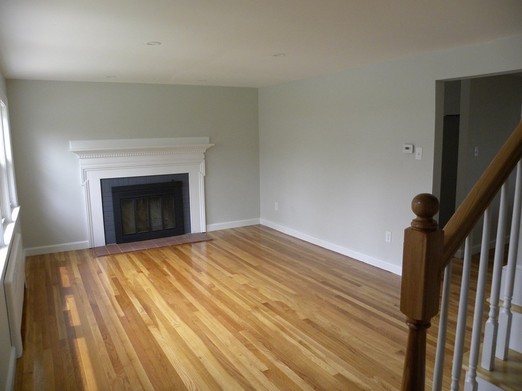 30 Arbor Road Chelmsford, MA 01863 - Photo 7 of 32 a view of empty room with wooden floor and fireplace