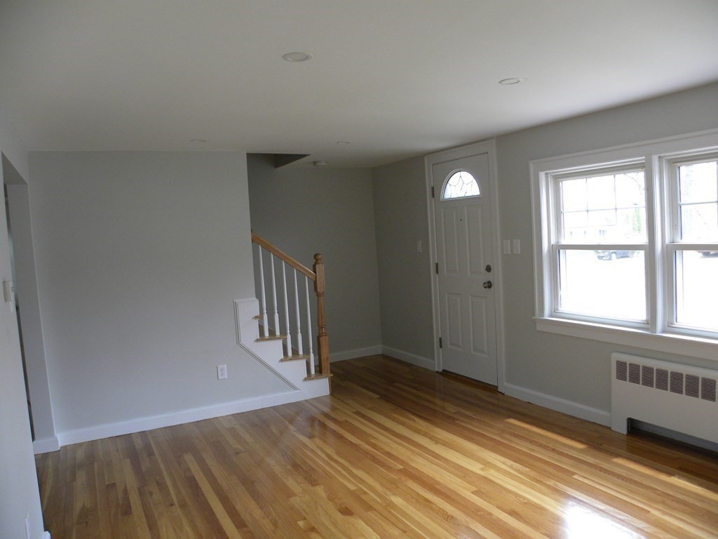 30 Arbor Road Chelmsford, MA 01863 - Photo 8 of 32 a view of an empty room with wooden floor and a window