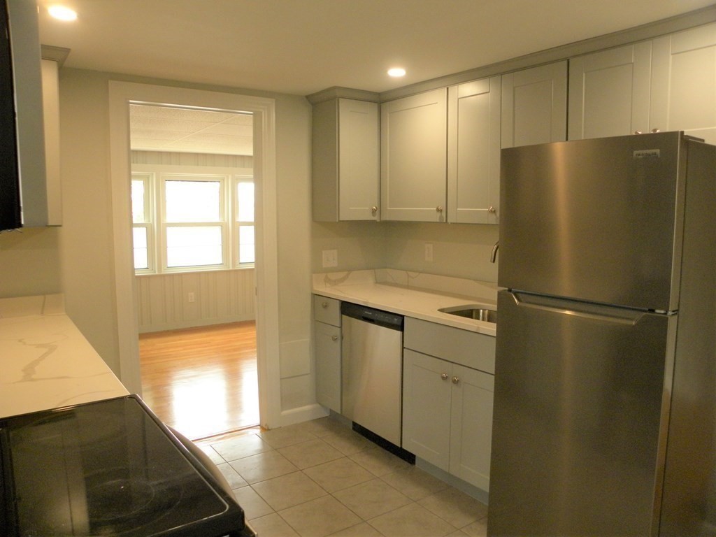 30 Arbor Road Chelmsford, MA 01863 - Photo 10 of 32 a white refrigerator freezer sitting inside of a kitchen