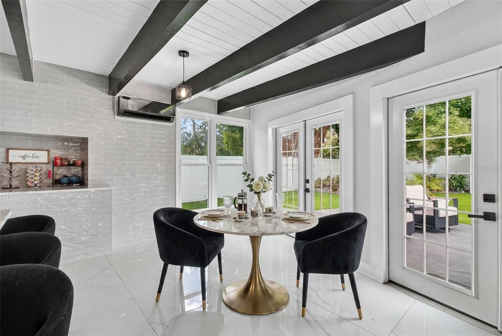 1714 Indian Rocks Road Belleair, FL 33756 - Photo 23 of 62 a dining room with furniture and a floor to ceiling window
