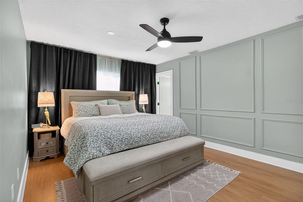 1714 Indian Rocks Road Belleair, FL 33756 - Photo 26 of 62 a spacious bedroom with a bed and a ceiling fan