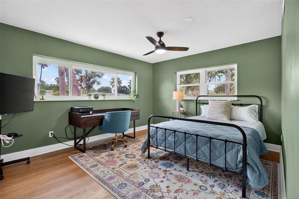 1714 Indian Rocks Road Belleair, FL 33756 - Photo 34 of 62 a bedroom with a bed and wooden floor