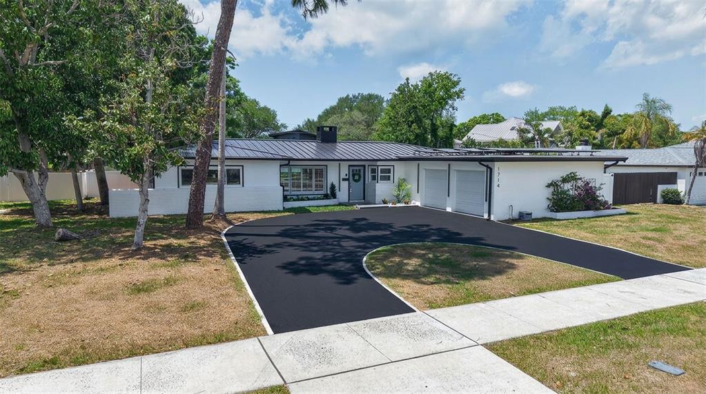 1714 Indian Rocks Road Belleair, FL 33756 - Photo 59 of 62 a front view of a house with a garden