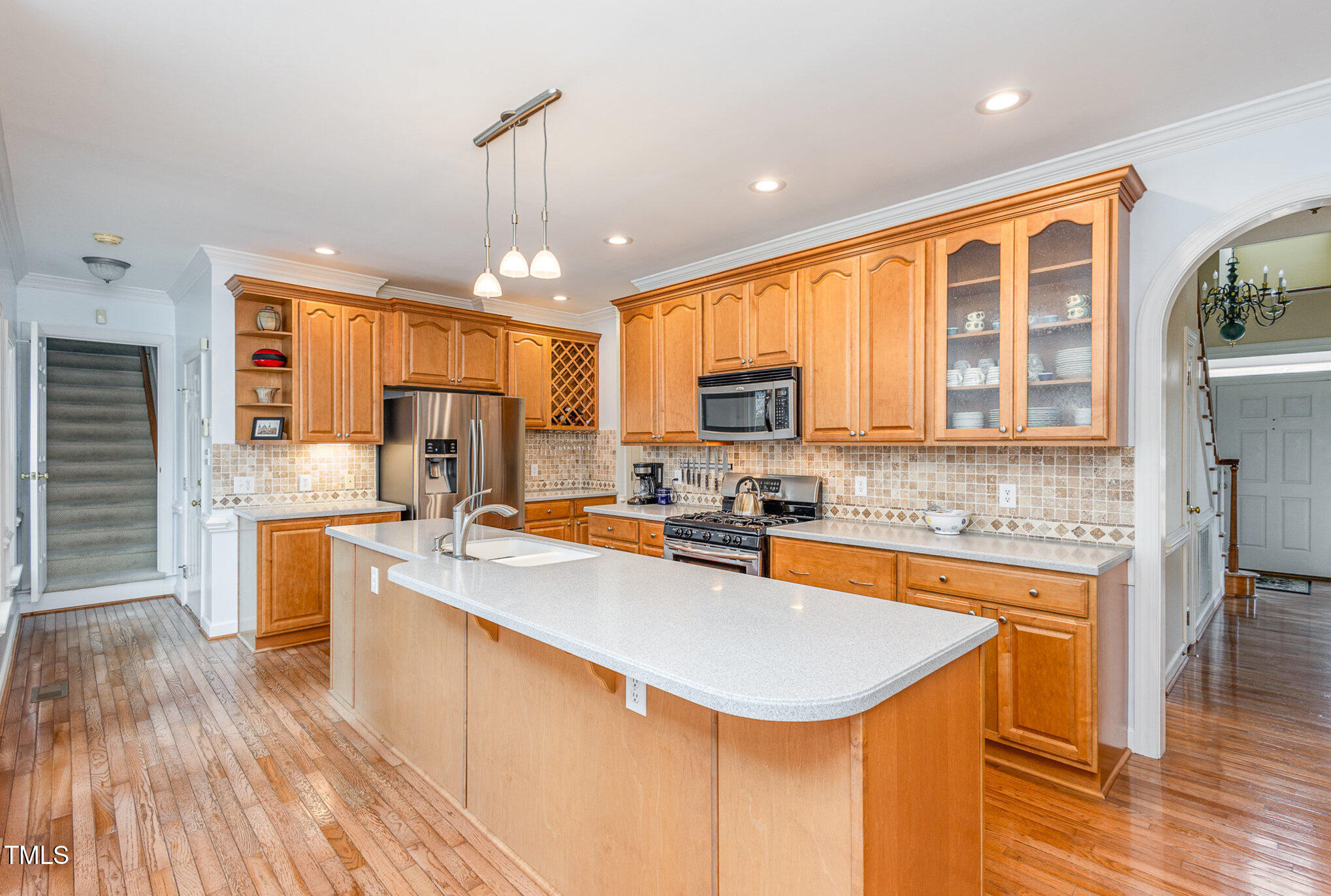 2719 Amstel Way Raleigh, NC 27613 - Photo 10 of 41 a kitchen with a refrigerator a stove top oven a sink dishwasher and wooden cabinets with wooden floor