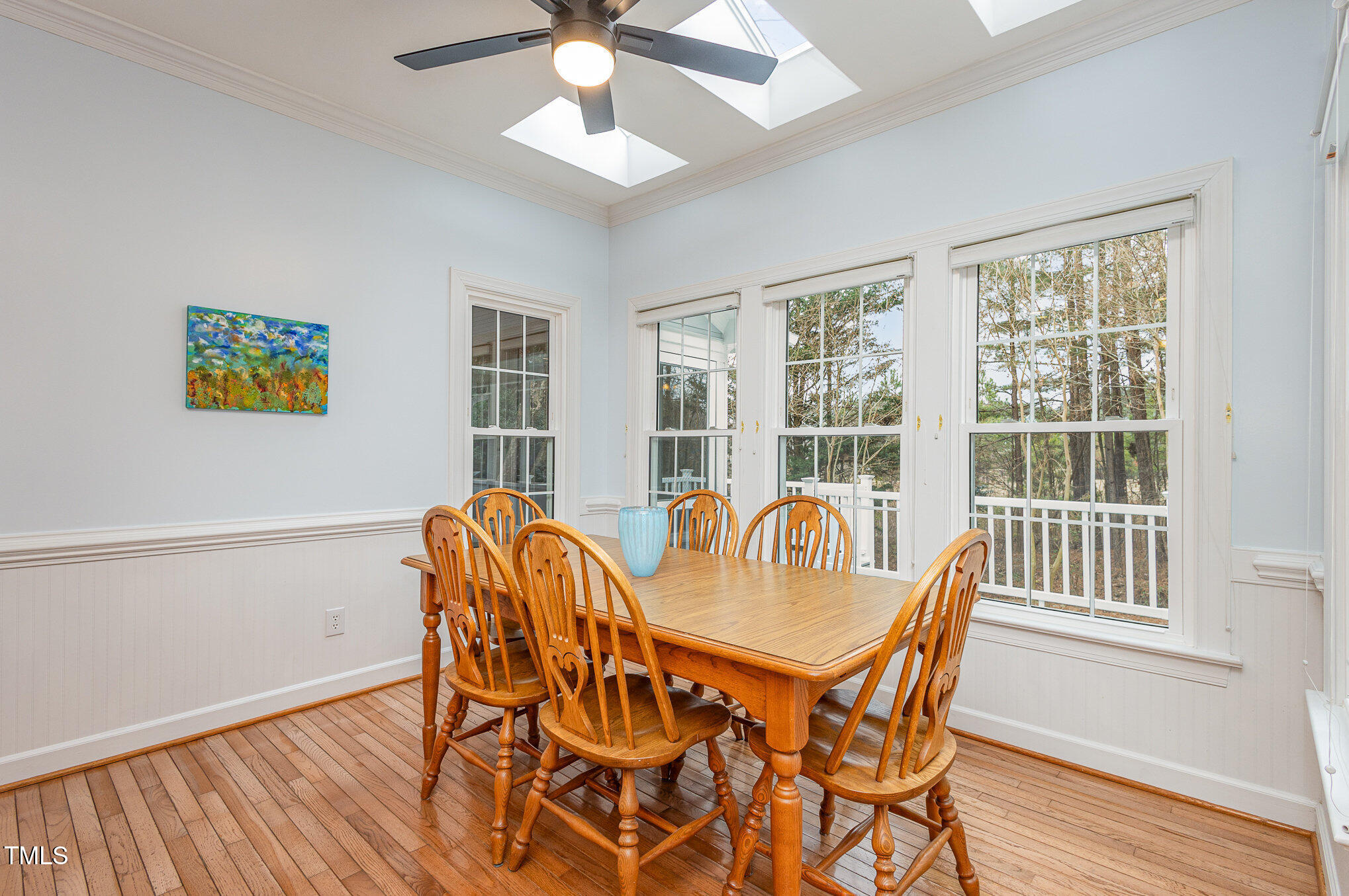 2719 Amstel Way Raleigh, NC 27613 - Photo 11 of 41 a view of a dining room with furniture a chandelier and wooden floor